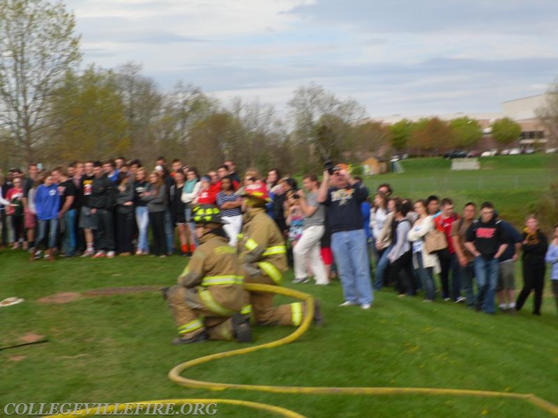 Fire suppression crew stands by in case of fire.